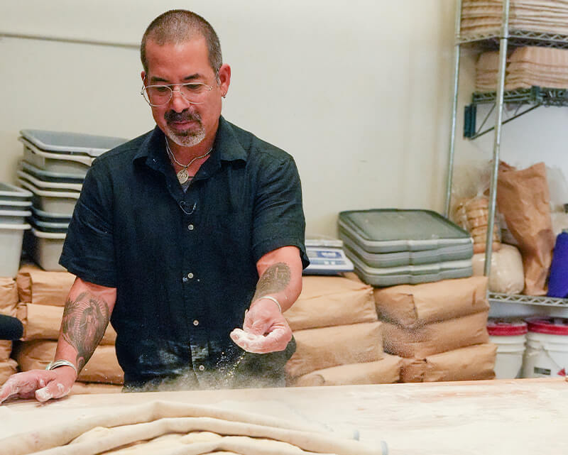 Don working on loaves at Barrio Bread bakery in Tucson.