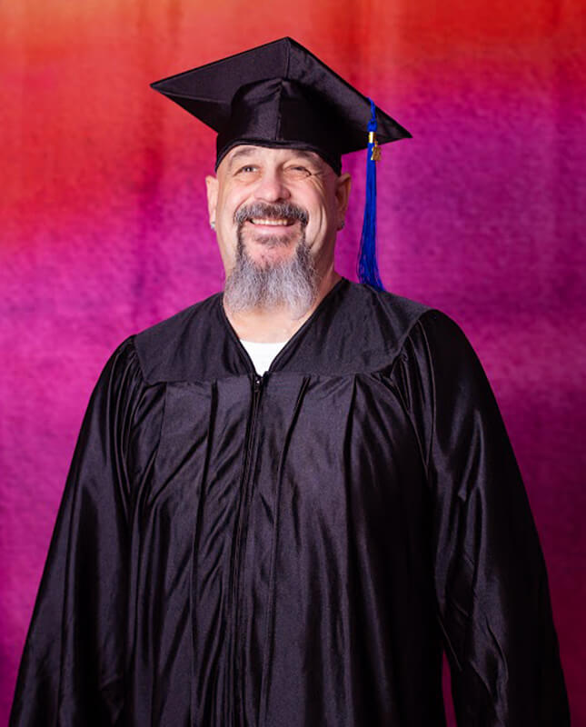 Sam poses for a graduation portrait.