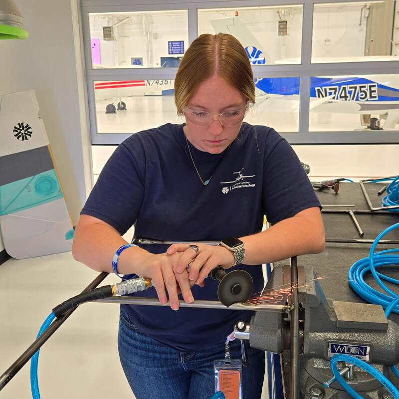 Sophie works on a aircraft part in a class